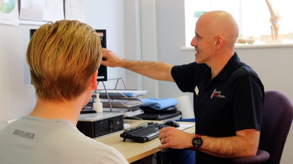 Clinician and Patient Explanation at Desk on Screen